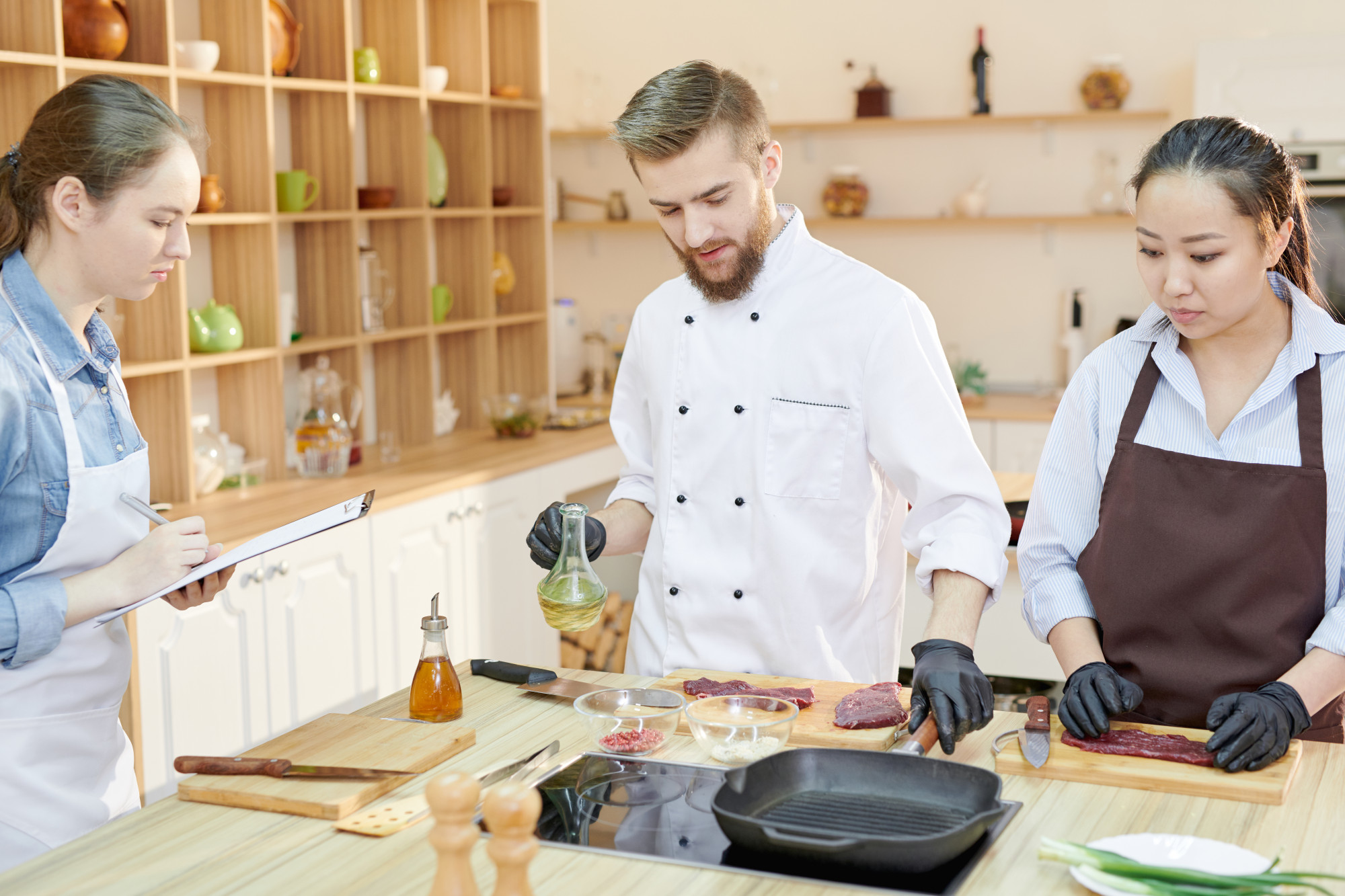 Workshop kitchen with chefs calibrating recipes